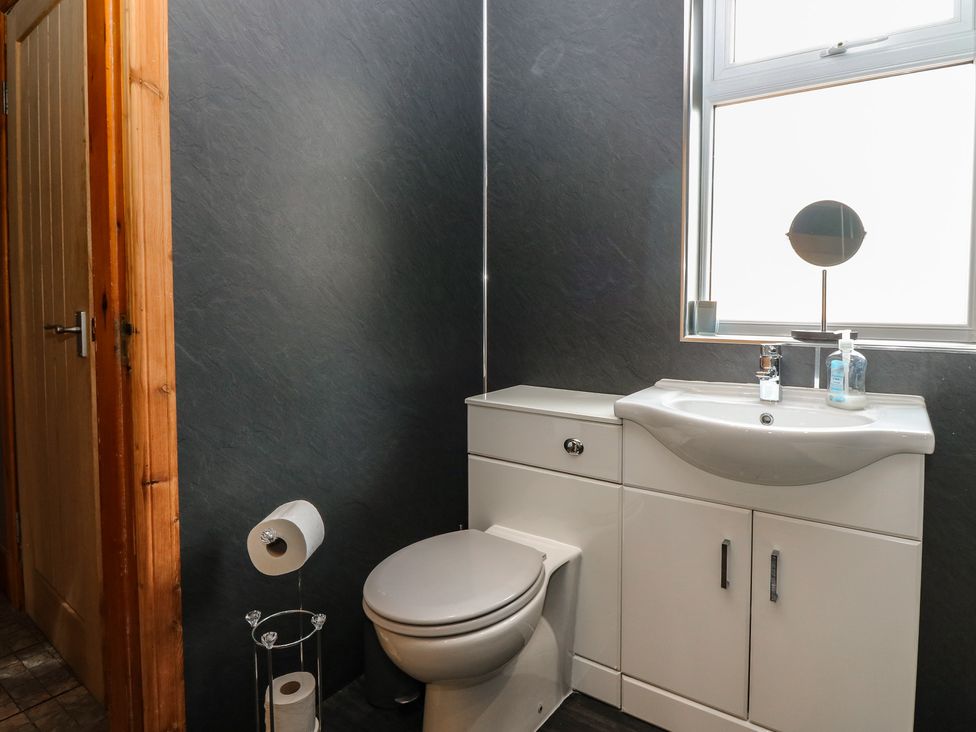 A bathroom with a toilet and sink at Rowan Cottage Redcastle near Arbroath