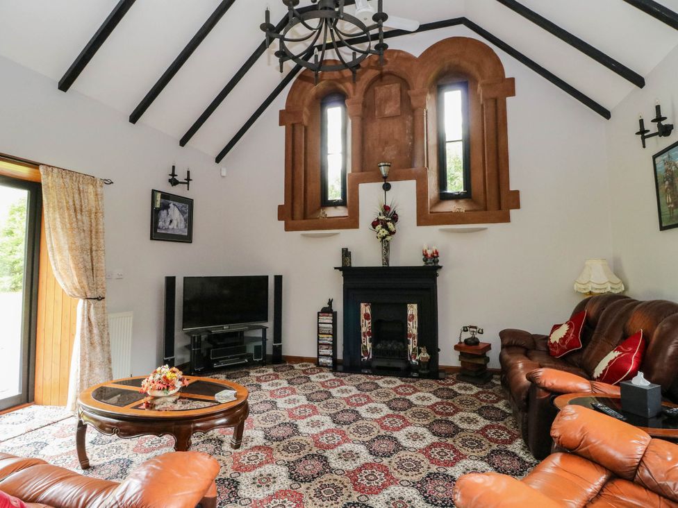 A living room with a television and sofa at Ardlui Church Inverarnan near Crianlarich