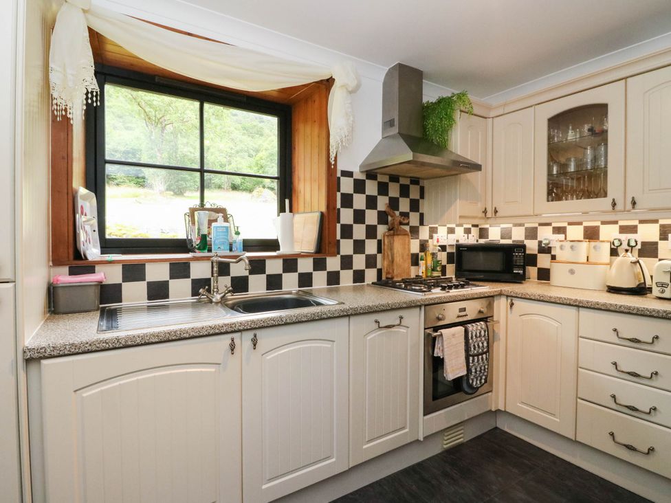A kitchen with a sink and stove at Ardlui Church in Inverarnan near Crianlarich