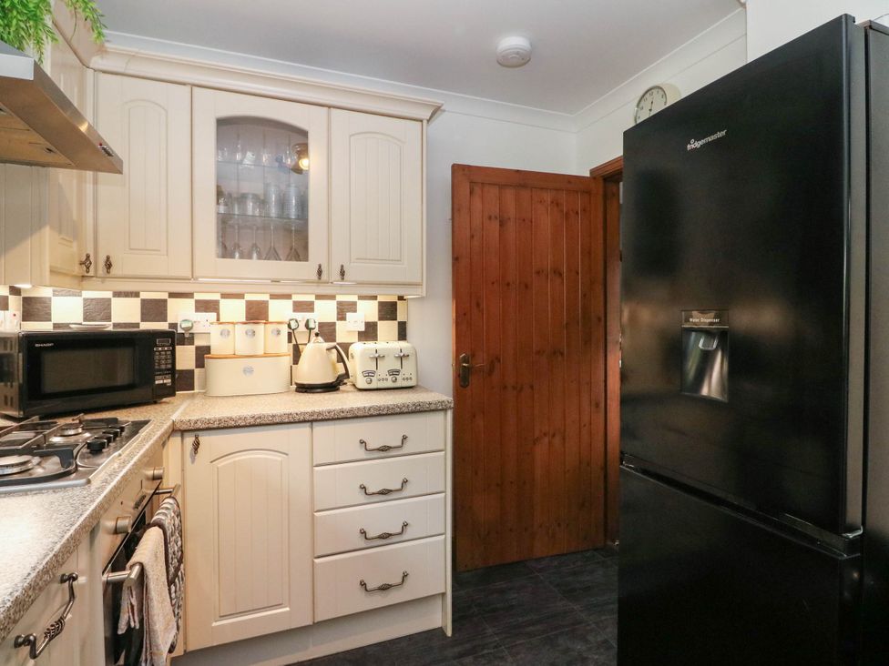 A kitchen with appliances and cabinets at Ardlui Church Inverarnan near Crianlarich