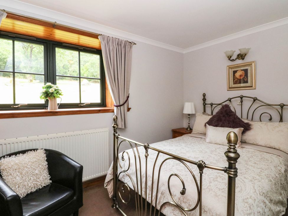 A bedroom with a bed and window at Ardlui Church Inverarnan near Crianlarich