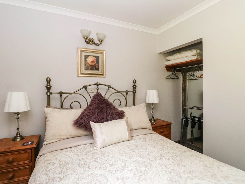 A bedroom with a bed and bedside tables at Ardlui Church in Inverarnan near Crianlarich