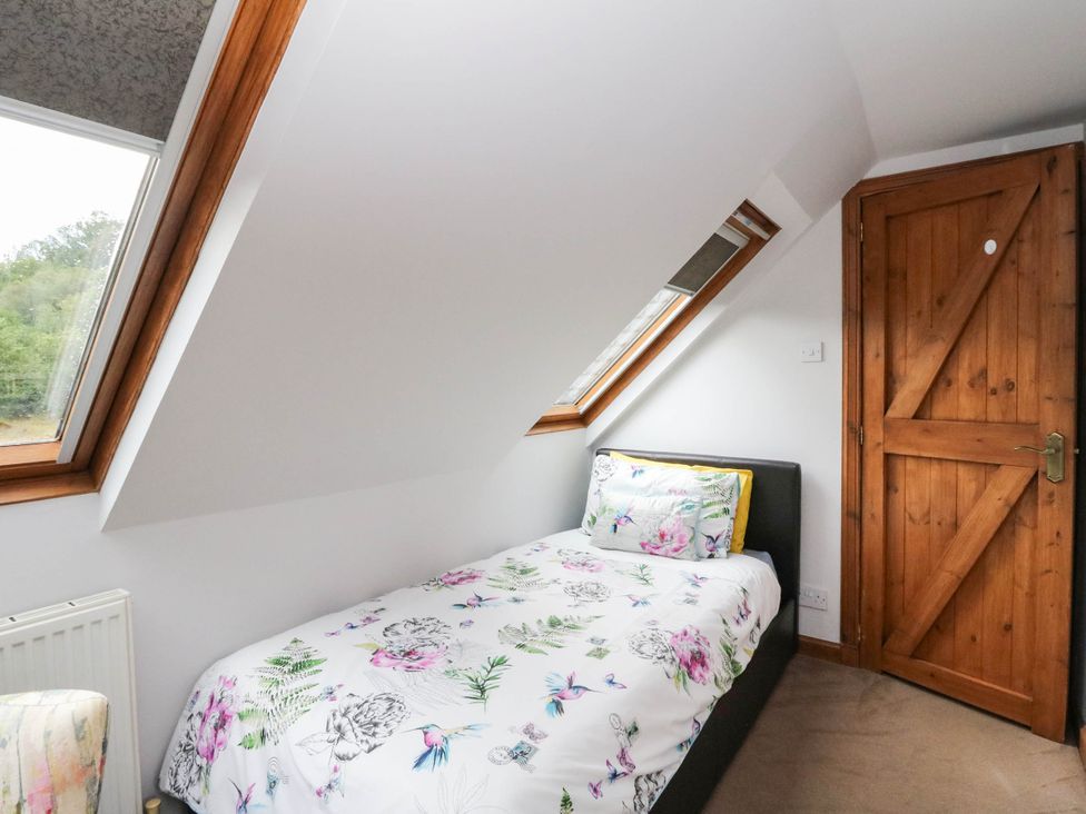 A bedroom with a bed and window at Ardlui Church Inverarnan near Crianlarich