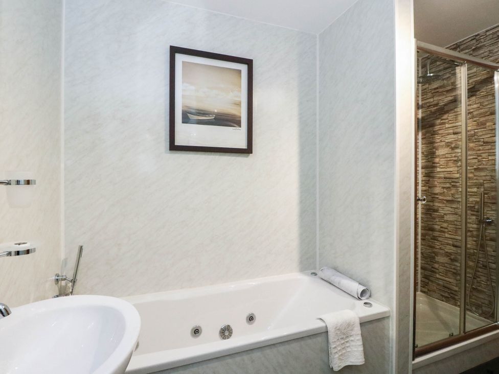 A bathroom with a bath tub and shower at Ardlui Church Inverarnan near Crianlarich