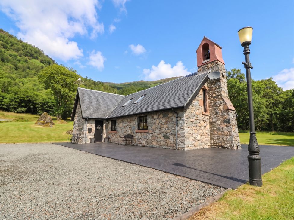 A stone building with windows and a chimney at Ardlui Church Inverarnan near Crianlarich