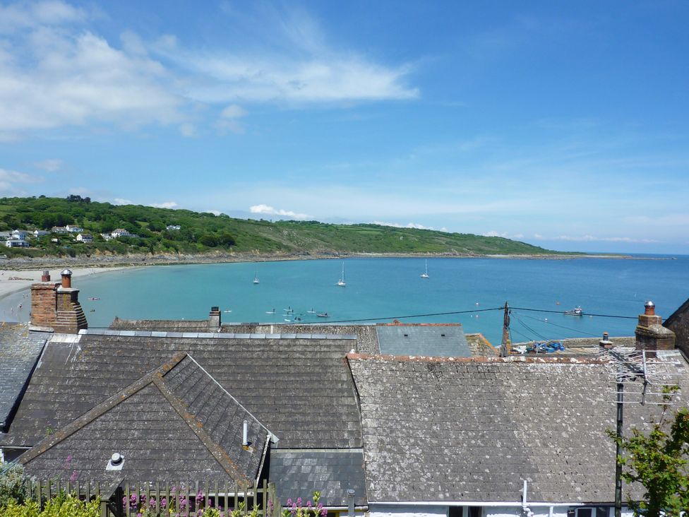 A view of the sea with boats and rooftops at The Mariners in Coverack
