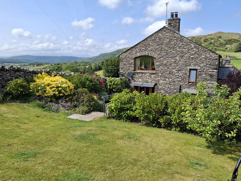 A stone house with a garden in front at Horse and Farrier Barn Newton in Cartmel near Cartmel
