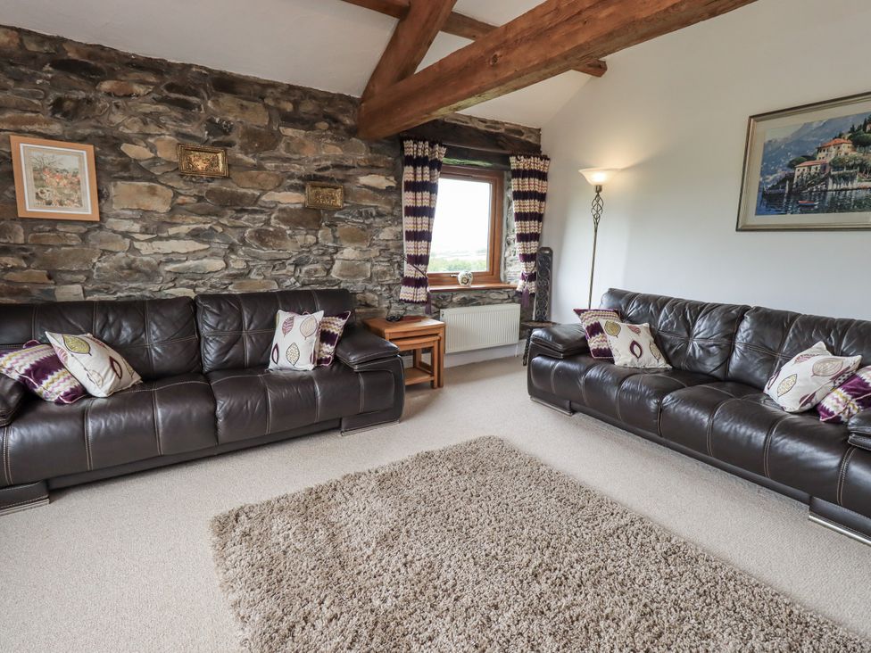 A living room with sofas and a window at Horse and Farrier Barn in Newton in Cartmel near Cartmel