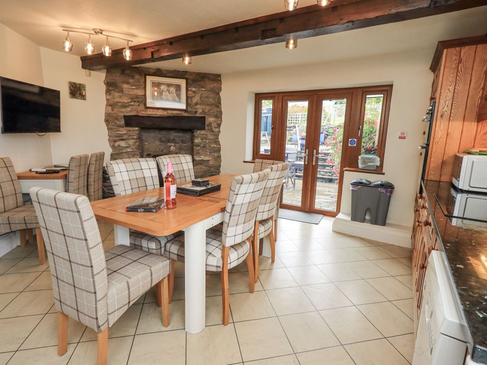 A dining room with a table and chairs at Horse and Farrier Barn in Newton in Cartmel near Cartmel