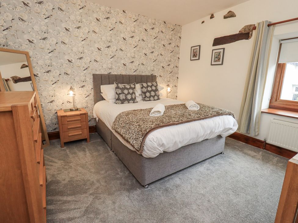 A bedroom with a bed and nightstand at Horse and Farrier Barn in Newton in Cartmel near Cartmel