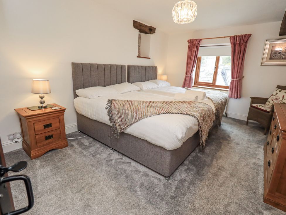 A bedroom with a bed and lamp at Horse and Farrier Barn in Newton in Cartmel near Cartmel