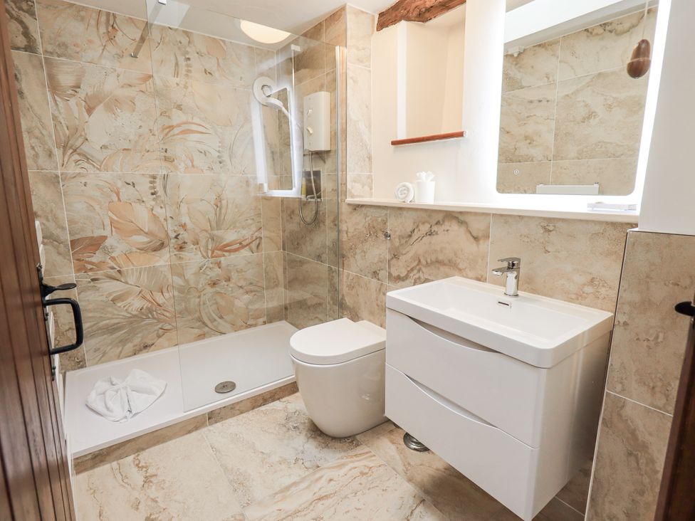 A bathroom with shower, toilet, and sink at Horse and Farrier Barn in Newton in Cartmel near Cartmel