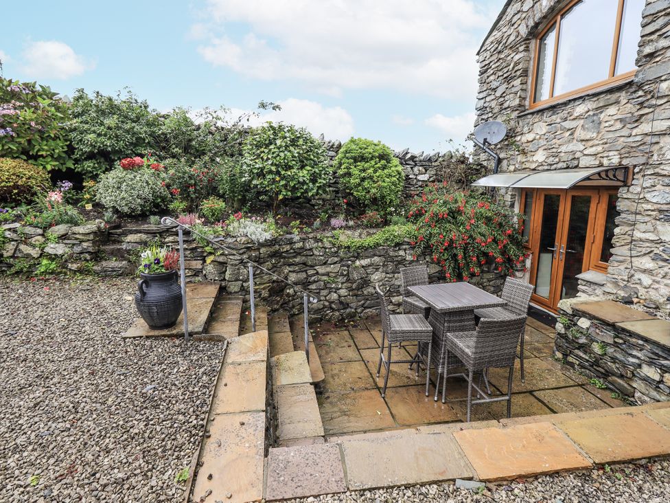 A garden area with a table and chairs at Horse and Farrier Barn in Newton in Cartmel near Cartmel