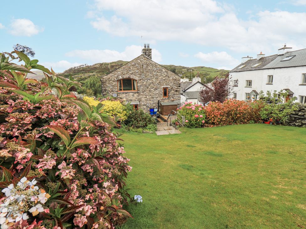 A garden with flowers and grass at Horse and Farrier Barn in Newton in Cartmel near Cartmel