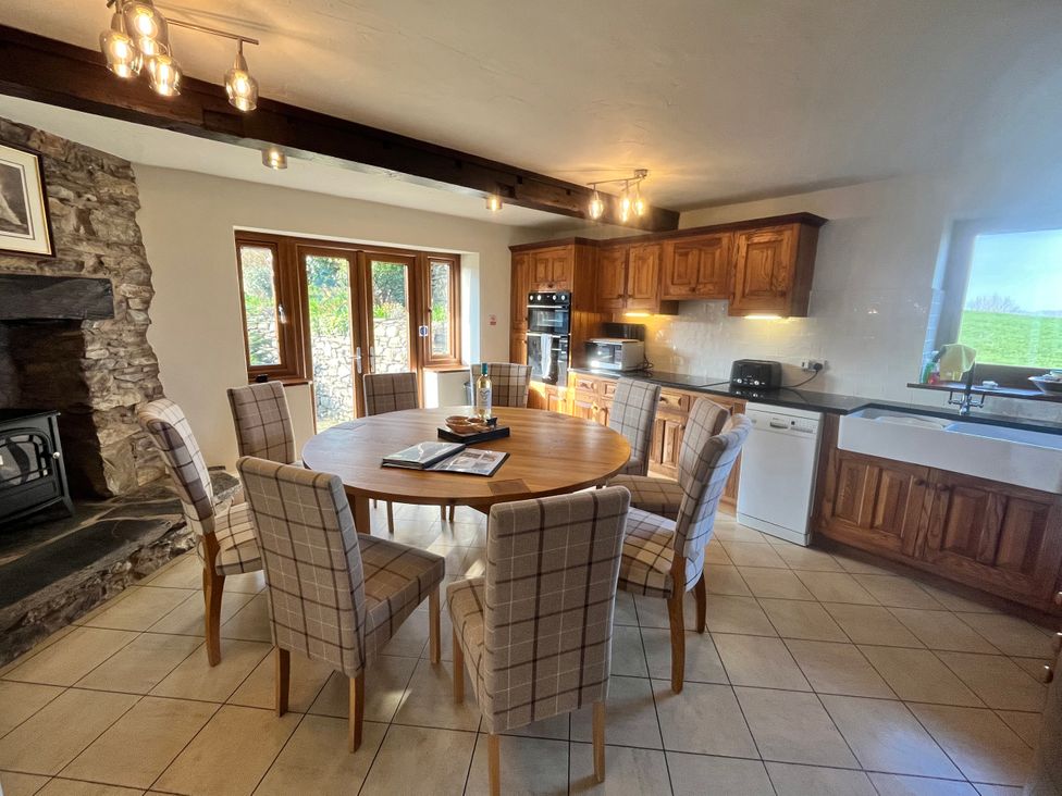 A kitchen with a dining table and chairs at Horse and Farrier Barn in Newton in Cartmel near Cartmel