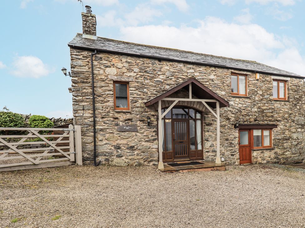 A stone house with front door and windows at Horse and Farrier Barn in Newton in Cartmel near Cartmel