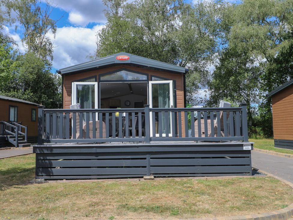 A mobile home with a deck and outdoor furniture at 18 Deer Glade in Landford