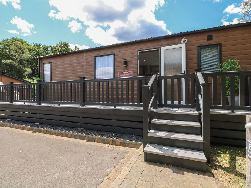 An exterior view of a cabin with steps and railing at 18 Deer Glade in Landford