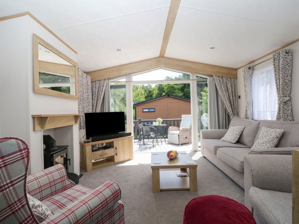 A living room with a sofa and television at 18 Deer Glade in Landford