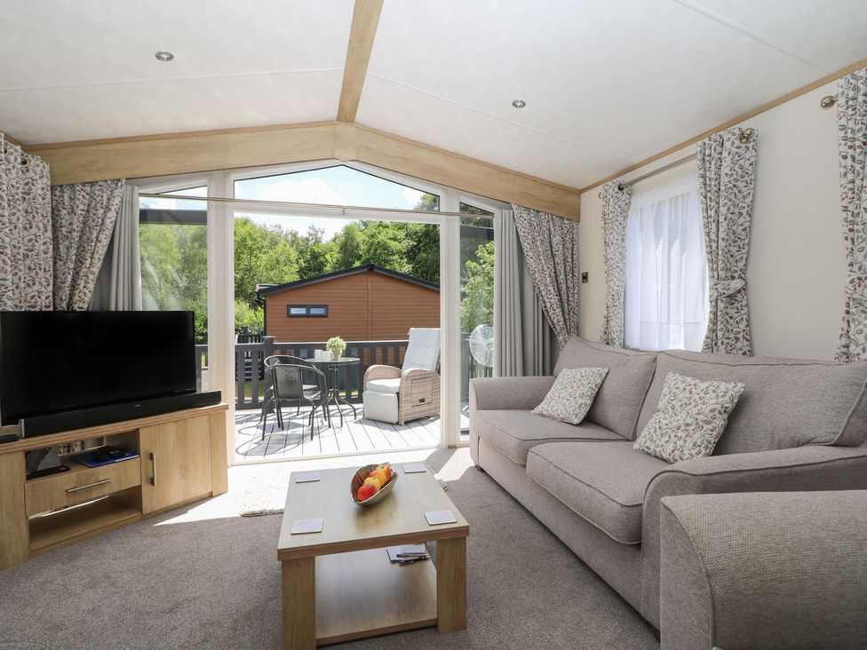 A living room with a sofa and television at 18 Deer Glade in Landford
