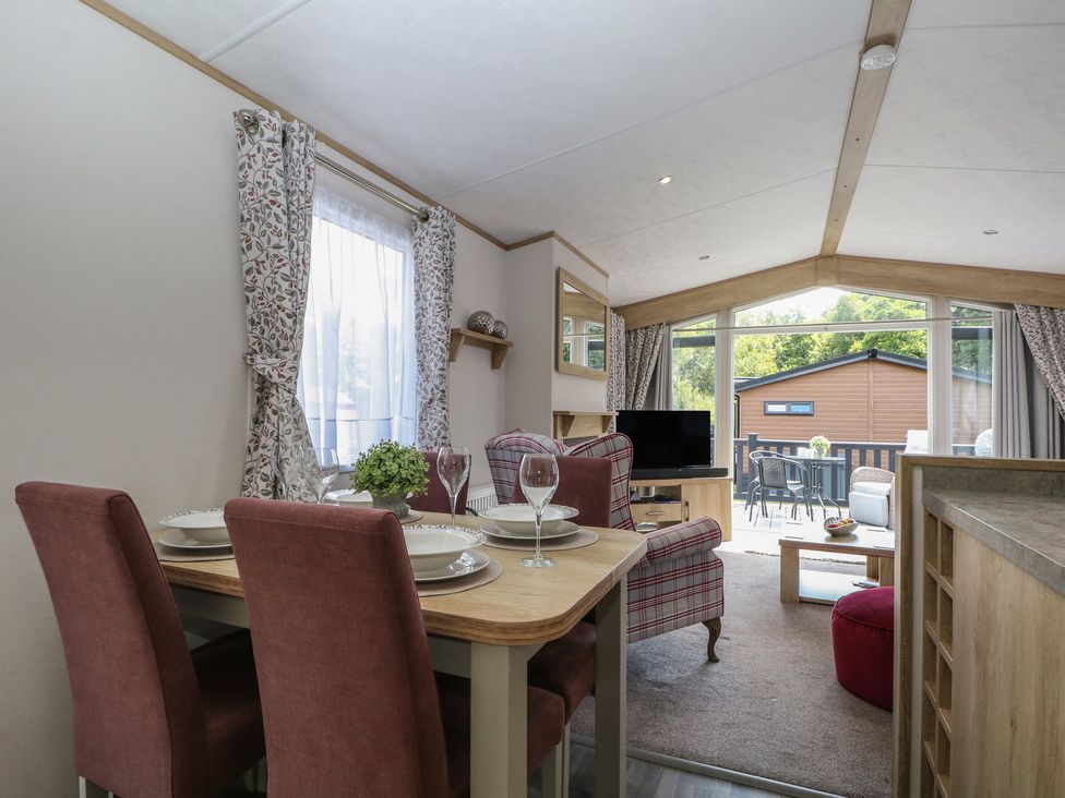 A dining area with a table and chairs at 18 Deer Glade in Landford