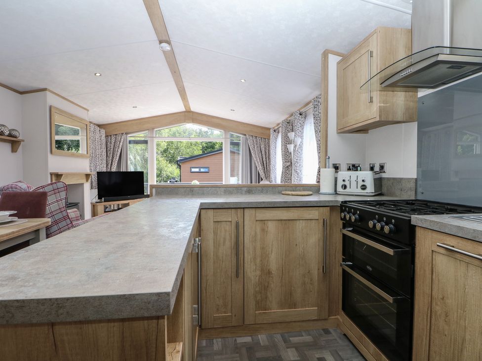 A kitchen with a countertop and appliances at 18 Deer Glade in Landford