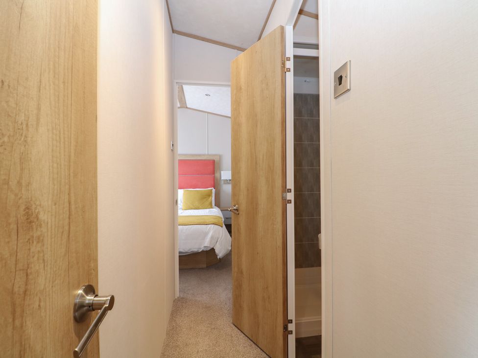 A view of a bedroom entrance with a bed and door at 18 Deer Glade in Landford