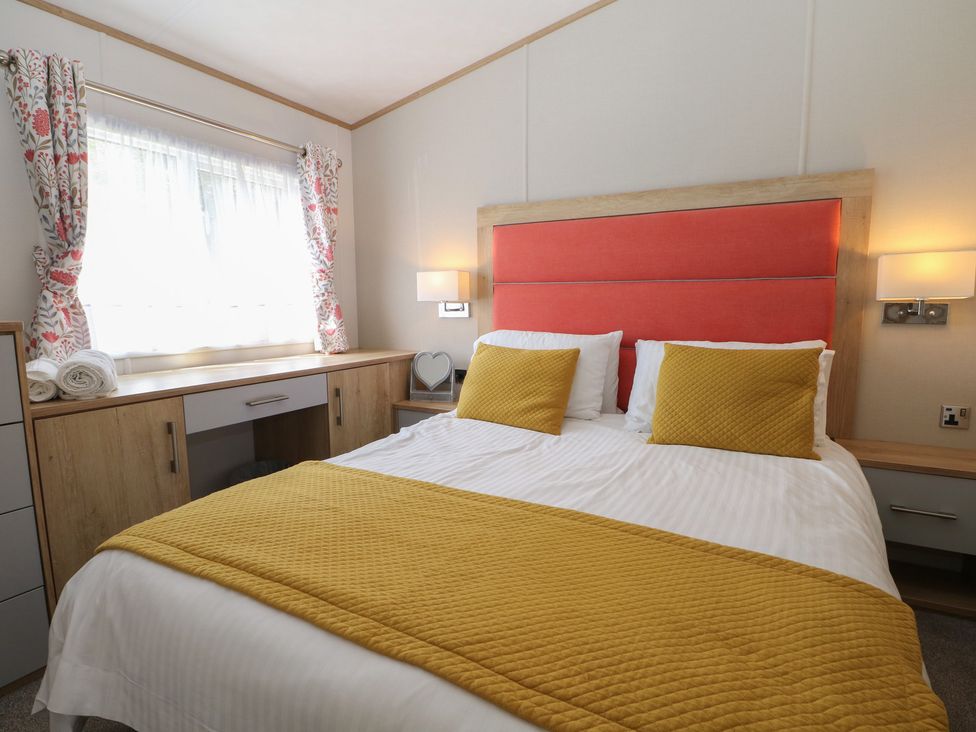 A bedroom with a bed and nightstand at 18 Deer Glade in Landford