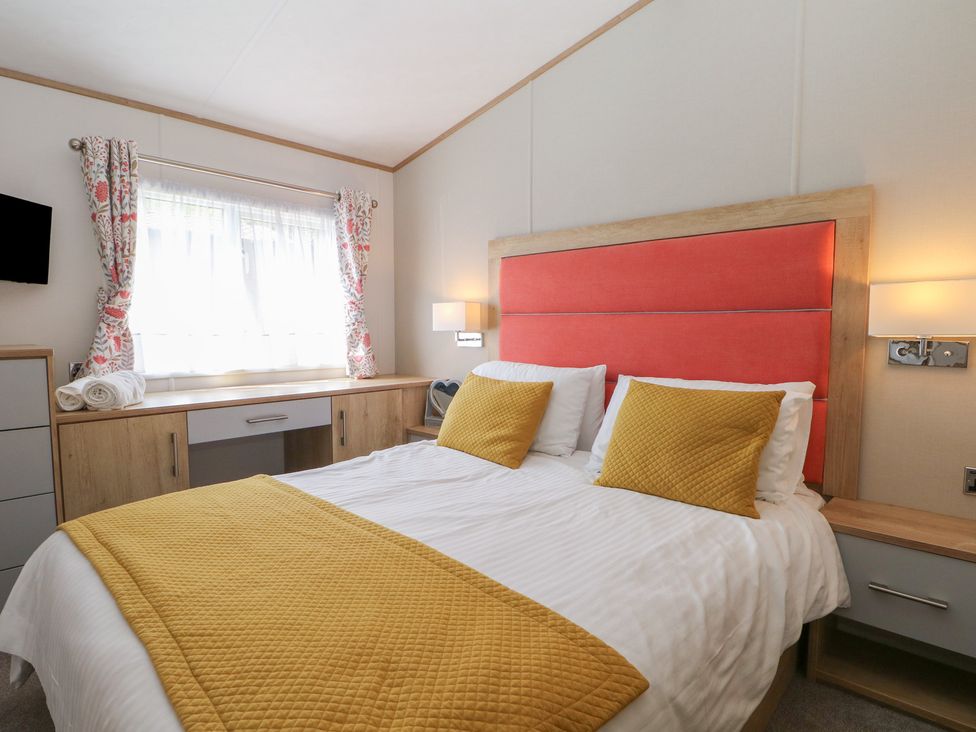 A bedroom with a bed and dresser at 18 Deer Glade in Landford