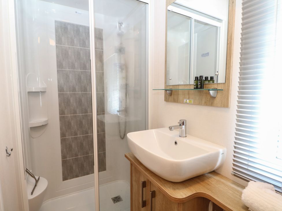 A bathroom with a shower and sink at 18 Deer Glade in Landford