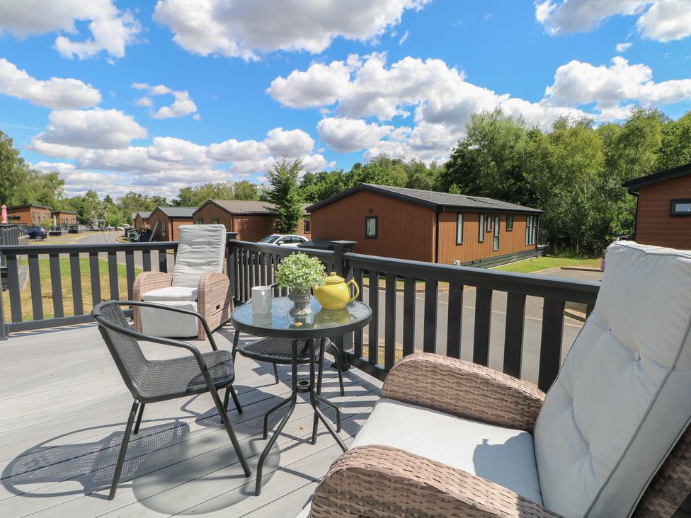 An outdoor terrace with seating and a table at 18 Deer Glade in Landford