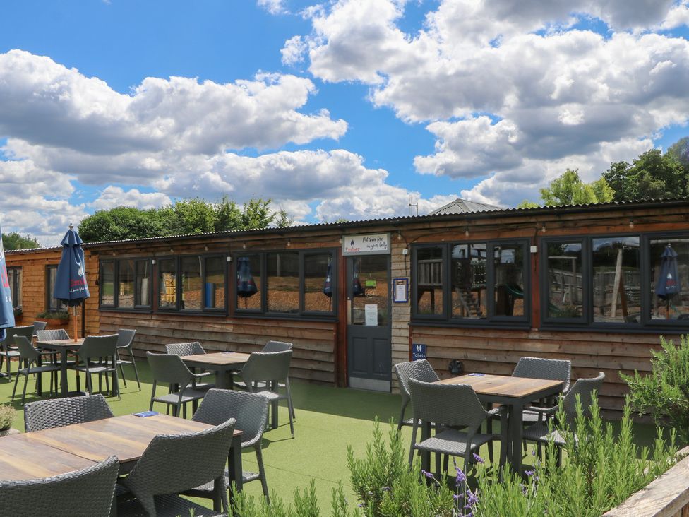 An outdoor seating area with tables and chairs at 18 Deer Glade in Landford
