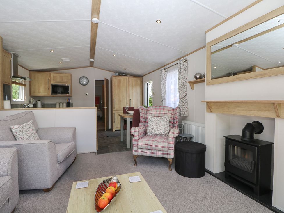 A living room with a sofa and a fireplace at 18 Deer Glade in Landford