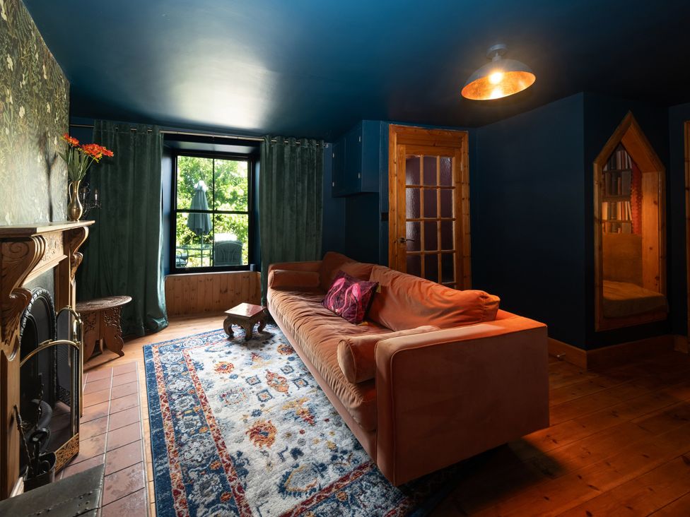 A living room with a sofa and fireplace at Wonderland in Tweedmouth, Berwick-Upon-Tweed