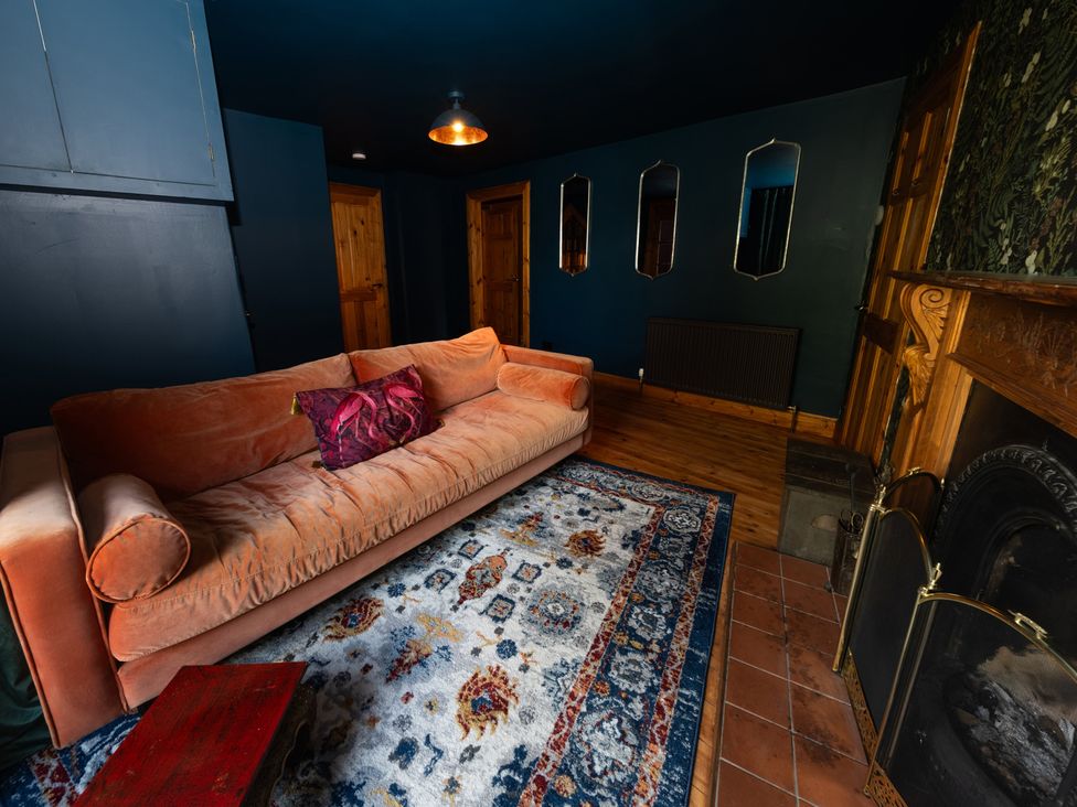 A living room with a sofa and a fireplace at Wonderland in Tweedmouth, Berwick-Upon-Tweed
