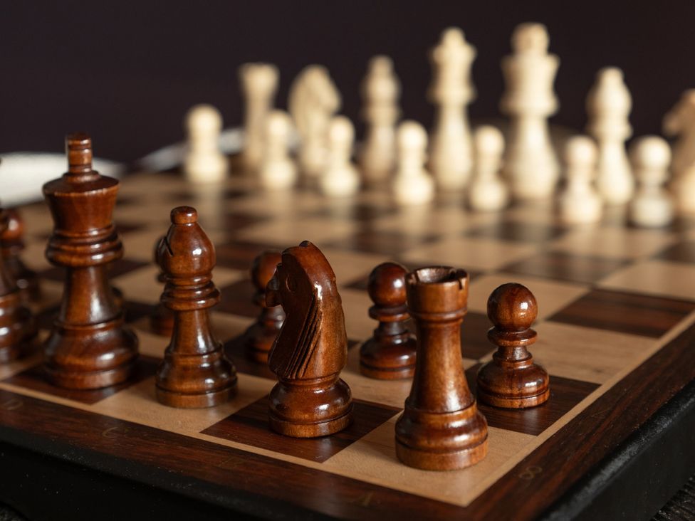 A chessboard with brown chess pieces at Wonderland in Tweedmouth, Berwick-Upon-Tweed