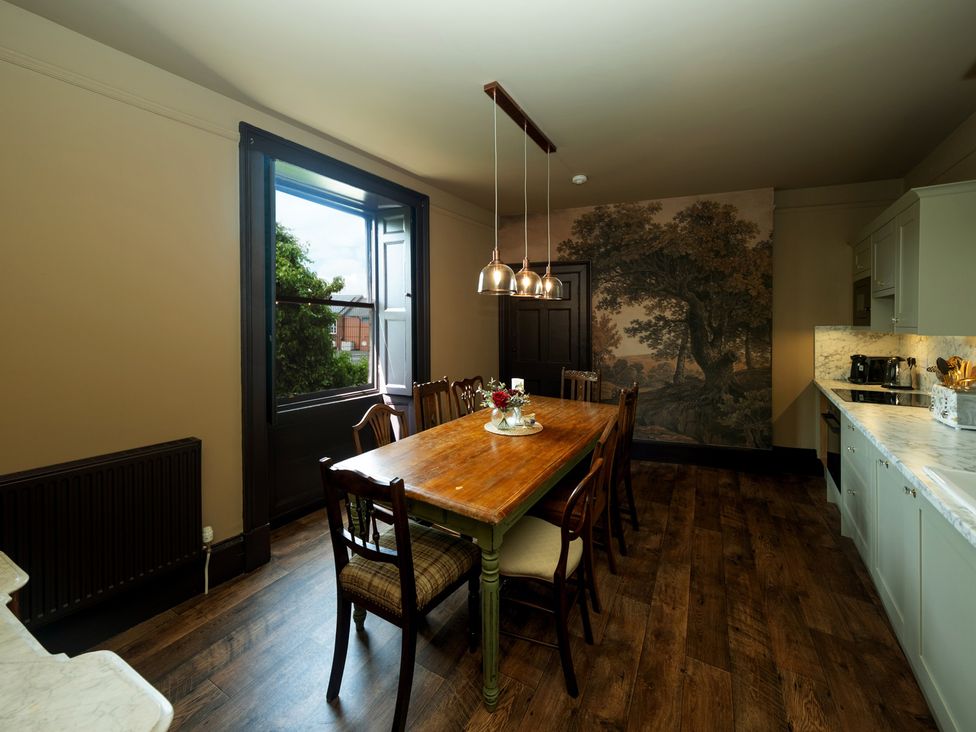 A dining room with a large table and chairs at Wonderland, Tweedmouth, Berwick-Upon-Tweed