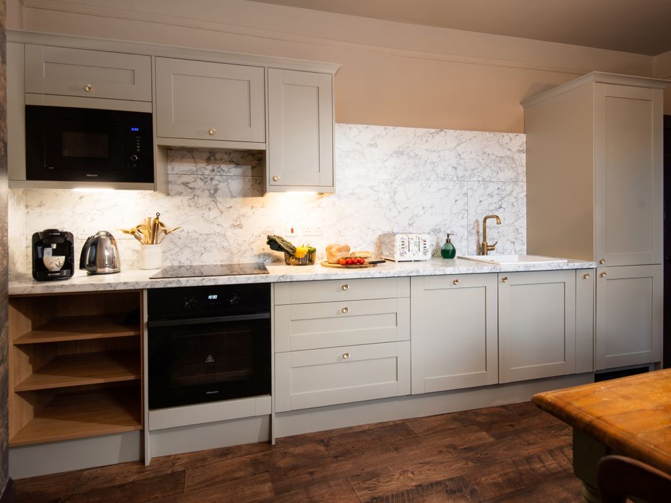 A kitchen with appliances and countertop at Wonderland in Tweedmouth, Berwick-Upon-Tweed