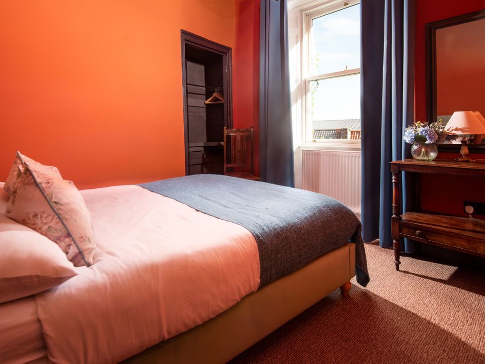 A bedroom with a bed and window at Wonderland in Tweedmouth, Berwick-Upon-Tweed