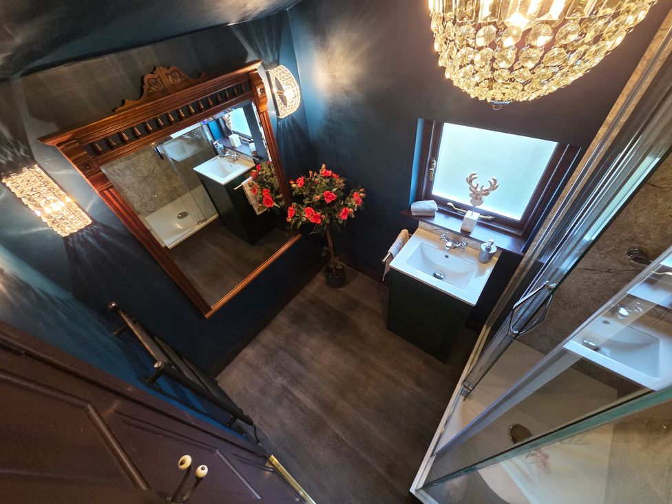 A bathroom with a mirror and sink at Wonderland in Tweedmouth, Berwick-Upon-Tweed