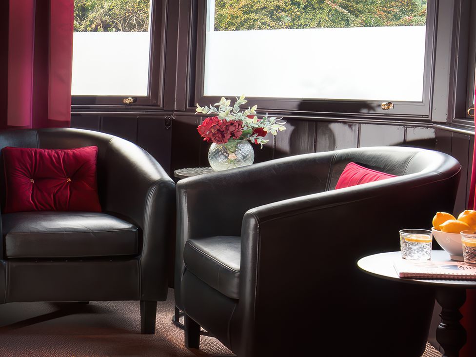 A sitting room with armchairs and a table at Wonderland in Tweedmouth, Berwick-Upon-Tweed