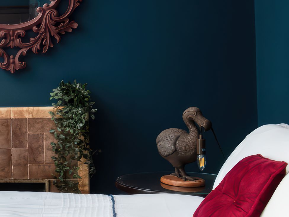 A bedroom with a lamp and plant decor at Wonderland in Tweedmouth, Berwick-Upon-Tweed