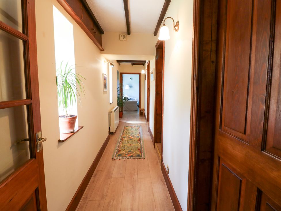 A hallway with doors and a plant at Mordon Moor Cottage Sedgefield, County Durham