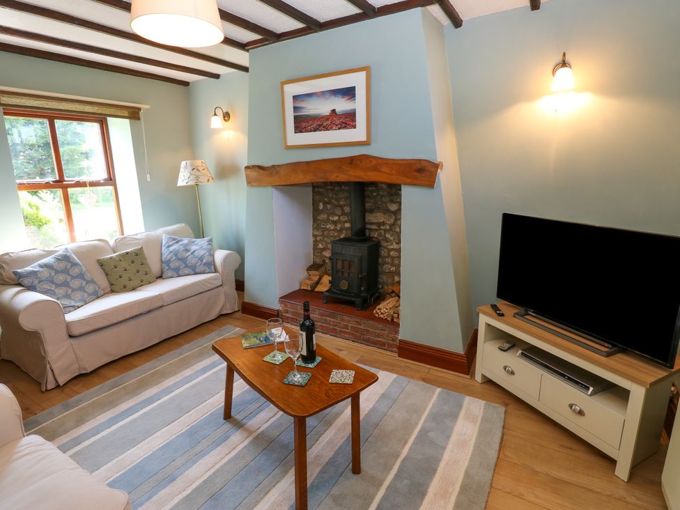 A living room with a fireplace and sofa at Mordon Moor Cottage Sedgefield, County Durham