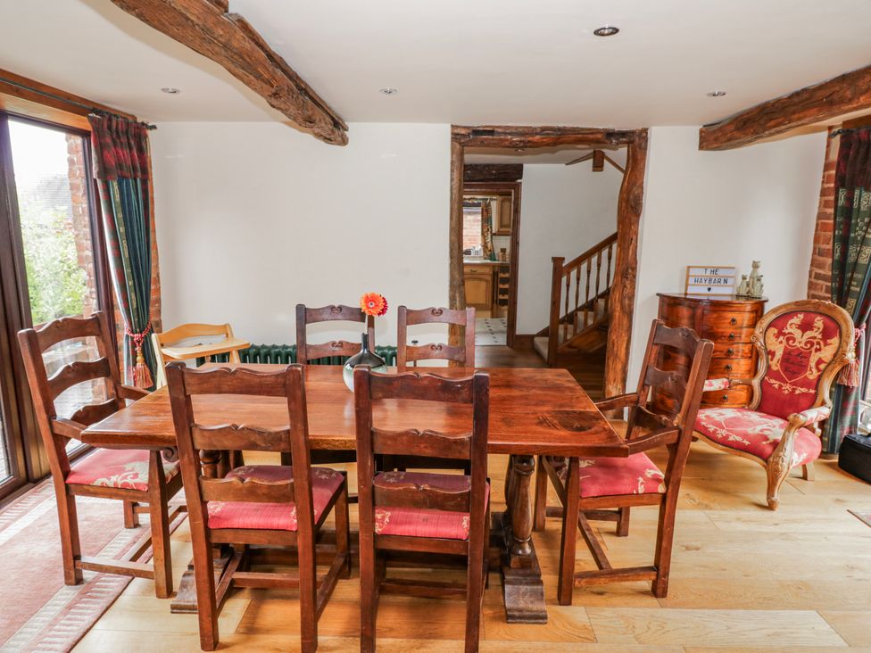 A dining room with a wooden table and chairs at The Haybarn in Lichfield