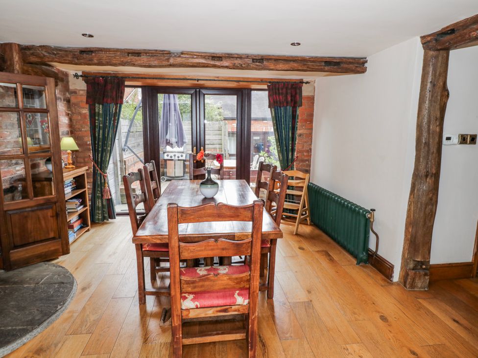 A dining room with a wooden table and chairs at The Haybarn in Lichfield