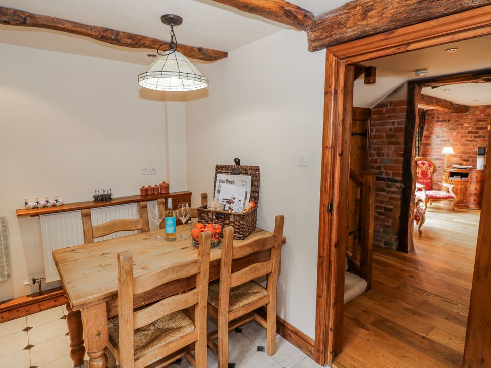 A dining room with a wooden table and chairs at The Haybarn in Lichfield
