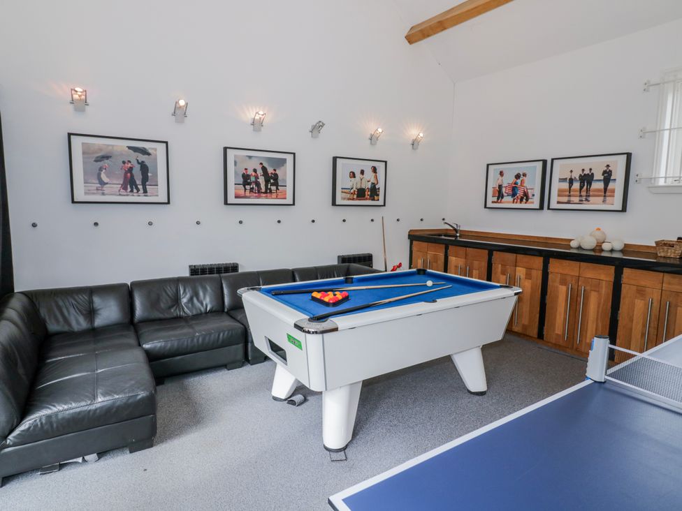 A game room with a pool table and ping pong table at The Haybarn in Lichfield
