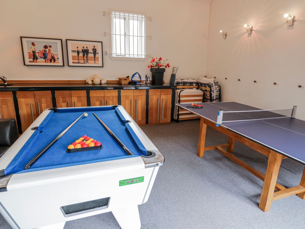 A game room with a pool table and a table tennis table at The Haybarn in Lichfield