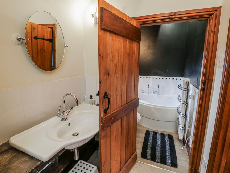 A bathroom with a sink and bathtub at The Haybarn in Lichfield
